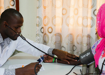 Health service provider with a client in Zimbabwe